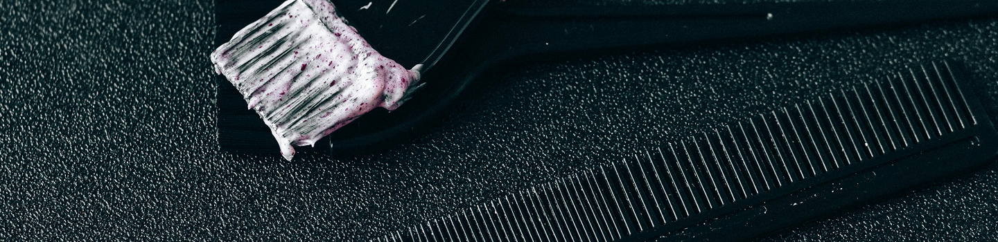 comb and hair dye on brush
