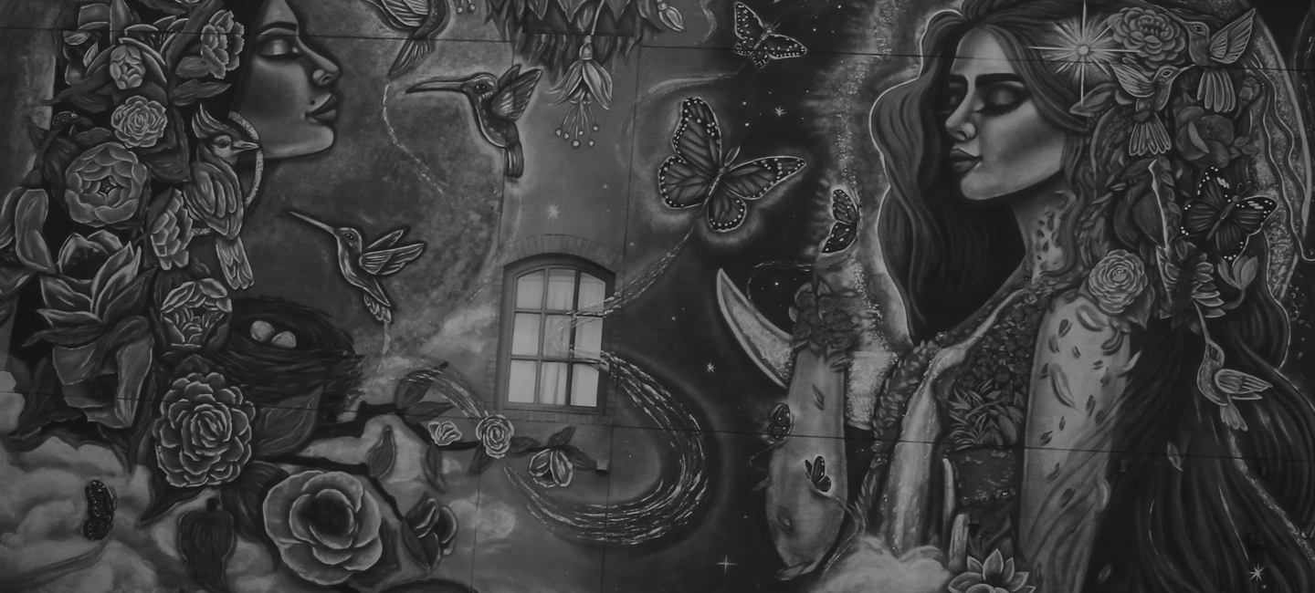 black and white photo of mural on the side of inspire at the grianery